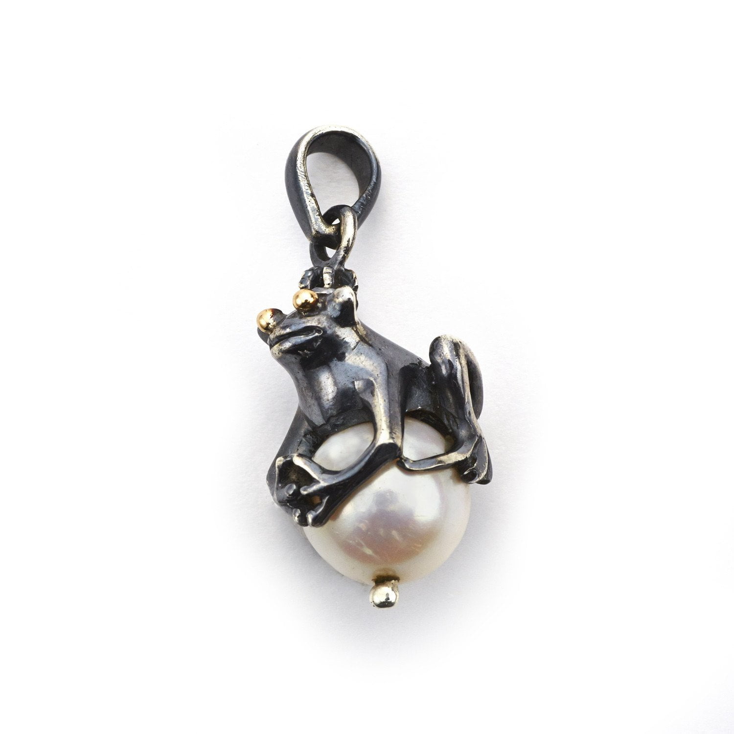 frog sitting on a pearl pendant made of silver
