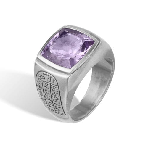 Sølvring med lilla sten og indgraverede symboler.